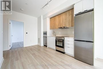 Markham (Greensborough) condo for rent - A kitchen with a refrigerator, oven, and stove top.
