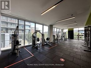 Toronto (South Riverdale) condo for rent - A gym with a view of a building outside the window.