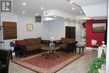 Vaughan (Vellore Village) apartment for rent - A living room with a brown sofa and a coffee table.