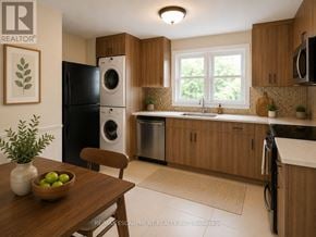 Hamilton (Huntington) multi-family for rent - A kitchen with wooden cabinets and a black fridge.
