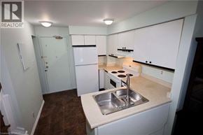 Kitchener townhouse for rent - A small kitchen with white cabinets and a sink.
