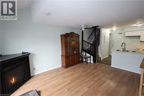 Kitchener townhouse for rent - A living room with a fireplace and a wooden floor.