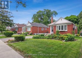 Toronto (Wexford-Maryvale) apartment for rent - A red brick house with a white window and a chimney is surrounded by greenery.