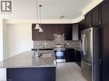 Cambridge apartment for rent - A modern kitchen with dark brown cabinets and stainless steel appliances.