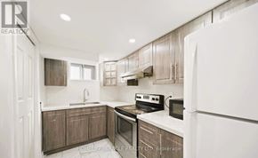 Toronto (Wexford-Maryvale) apartment for rent - A modern kitchen with wooden cabinets and stainless steel appliances.