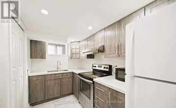Toronto (Wexford-Maryvale) apartment for rent - A modern kitchen with wooden cabinets and stainless steel appliances.