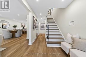 Toronto (L'amoreaux) apartment for rent - A spacious living room with a staircase leading to the upper floor.