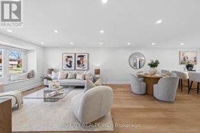 Toronto (L'amoreaux) apartment for rent - A spacious living room with a glass coffee table and a large mirror on the wall.