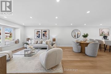 Toronto (L'amoreaux) apartment for rent - A spacious living room with a glass coffee table and a large mirror on the wall.