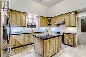 King (Nobleton) apartment for rent - A kitchen with wooden cabinets and a black countertop.