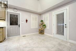 King (Nobleton) apartment for rent - A real estate listing image of a room with a clock, two doors, and a plant.
