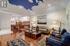 King (Nobleton) apartment for rent - A living room with a staircase and a painting on the wall.