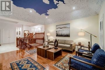 King (Nobleton) apartment for rent - A living room with a staircase and a painting on the wall.