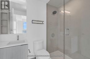 Vaughan (Vaughan Corporate Centre) condo for rent - A white bathroom with a glass shower door and a white toilet.