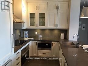 Markham (Angus Glen) condo for rent - A kitchen with a sink, stove, and cabinets.