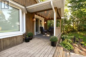 Caledon apartment for rent - A wooden deck with a white roof and a glass door leading to a patio.