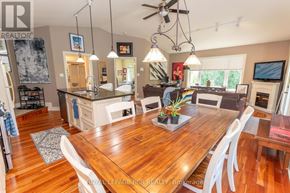 Caledon apartment for rent - A well-lit dining room with a wooden table and chairs.