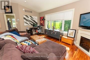 Caledon apartment for rent - A living room with a brown couch and a fireplace.