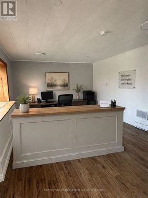 Kawartha Lakes (Bobcaygeon) multi-family for rent - A realtor's office with a wooden reception desk and a framed picture on the wall.