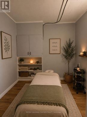 Kawartha Lakes (Bobcaygeon) multi-family for rent - A bedroom with a bed, a shelf with plants, and a framed quote on the wall.