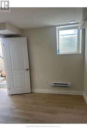 Brantford apartment for rent - A room with a white door and a window with blinds.