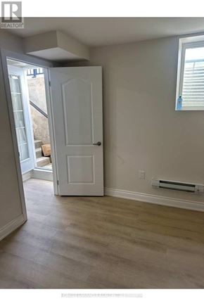 Brantford apartment for rent - A room with a white door and a window with blinds.