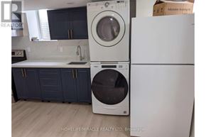 Brantford apartment for rent - A white washing machine and dryer in a kitchen.