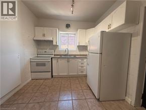 Hamilton apartment for rent - A kitchen with white cabinets and appliances.