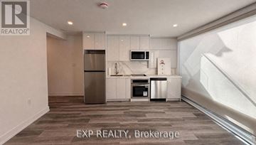 Toronto (East End-Danforth) apartment for rent - A modern kitchen with a refrigerator, microwave, oven, and sink.