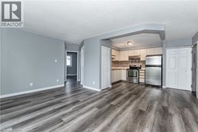 Waterloo condo for rent - A spacious kitchen with a refrigerator, oven, and microwave.