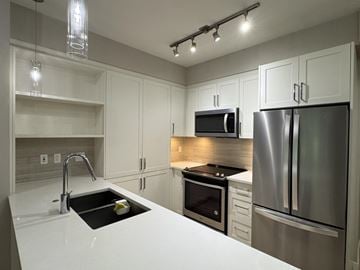 Langley apartment for rent - A modern kitchen with a stainless steel refrigerator and microwave.
