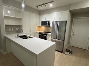Langley apartment for rent - A kitchen with a white counter top and stainless steel appliances.