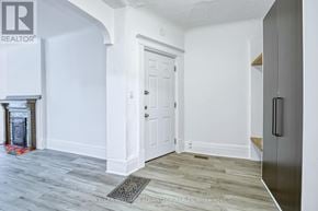Toronto (Cabbagetown-South St. James Town) apartment for rent - A white door is in a hallway with wood flooring.