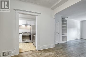 Toronto (Cabbagetown-South St. James Town) apartment for rent - A white kitchen with a refrigerator, sink, and cabinets is shown in the image.