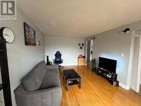 Oshawa (Donevan) apartment for rent - A living room with a grey couch and a black coffee table.