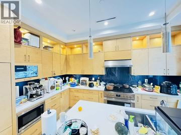 Vancouver apartment for rent - A kitchen with wooden cabinets and a white countertop.