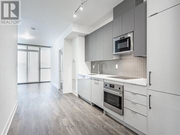 Vaughan (Concord) condo for rent - A modern kitchen with white cabinets and stainless steel appliances.