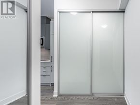 Vaughan (Concord) condo for rent - A glass door separates two rooms.