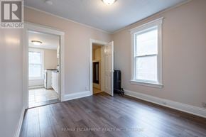 Hamilton (Stipley) multi-family for rent - A room with a window and a door leading to another room.