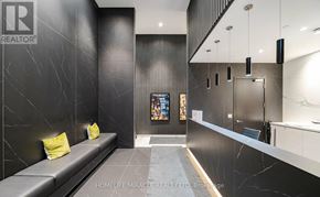 Toronto (Bay Street Corridor) condo for rent - A modern waiting area with a bench and a television.