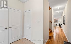 Oshawa (Kedron) apartment for rent - A hallway with white doors and wooden floors.