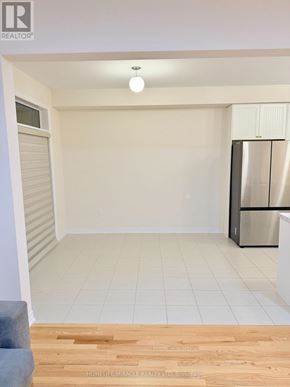 Oshawa (Kedron) apartment for rent - A kitchen with white cabinets and a stainless steel refrigerator.