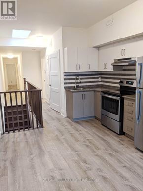 Toronto (Dovercourt-Wallace Emerson-Junction) apartment for rent - A kitchen with a refrigerator, oven, and sink.