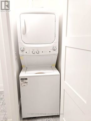 Toronto (Dovercourt-Wallace Emerson-Junction) apartment for rent - A white dryer is sitting in a small closet.