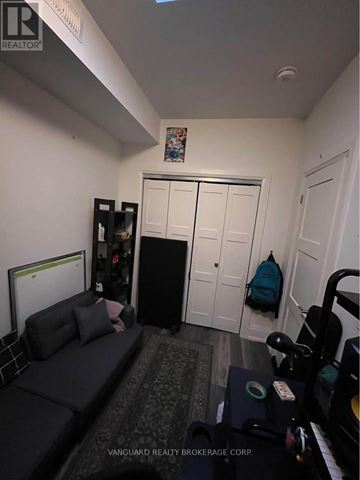 Toronto (Dovercourt-Wallace Emerson-Junction) apartment for rent - A living room with a grey couch and a black refrigerator.