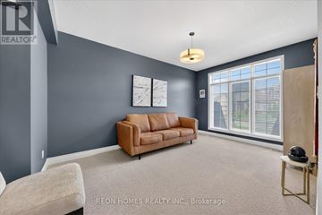 London North (North R) apartment for rent - A living room with a brown couch and a white chair.