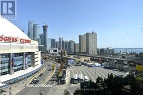 Toronto (Waterfront Communities) condo for rent - A cityscape with a clear blue sky and a sign that reads "REALTOR".