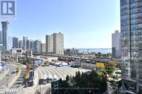 Toronto (Waterfront Communities) condo for rent - A cityscape with a clear blue sky and a highway in the foreground.