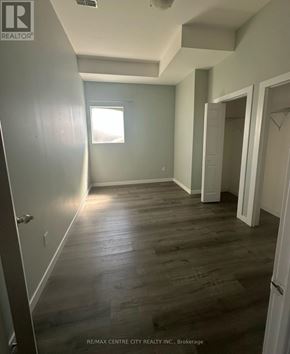 London East (East K) multi-family for rent - A room with wood flooring and a window.