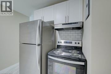 Cambridge apartment for rent - A kitchen with a stainless steel refrigerator and stove.